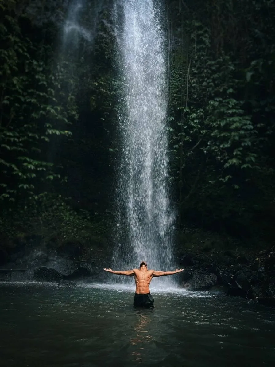 Maddy — meditation, arms spread under waterfall